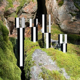 Handmade crystal glass sculptures photographed in an organic setting, creating a contrast between structure and nature. Design from Finland.